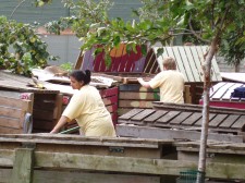 Workers tending colourfully painted compost bins at a Community Compost project